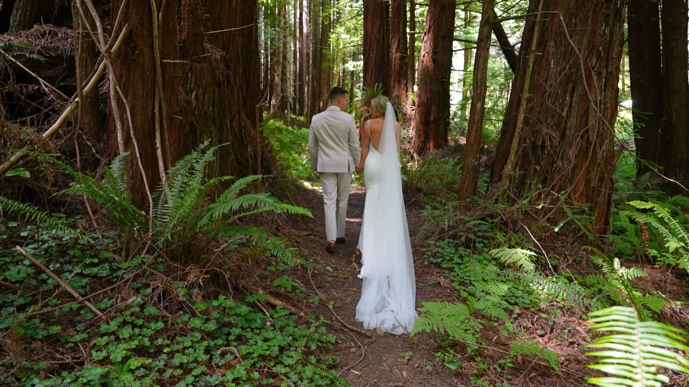 Jessica and Ryan beneath towering coastal redwoods at The Inn at Newport Ranch
