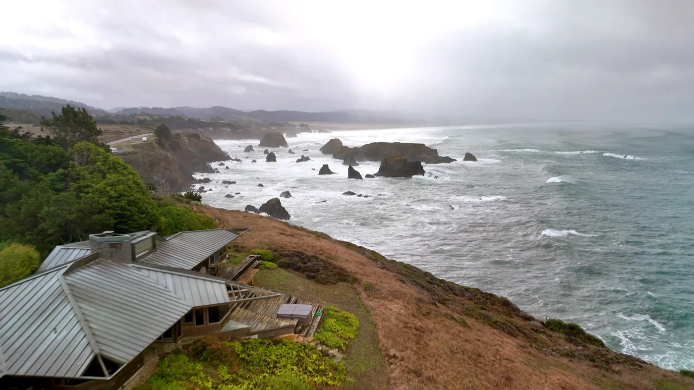 Rajni and Igor against the dramatic Pacific coastline at The Inn at Newport Ranch during stormy weather
